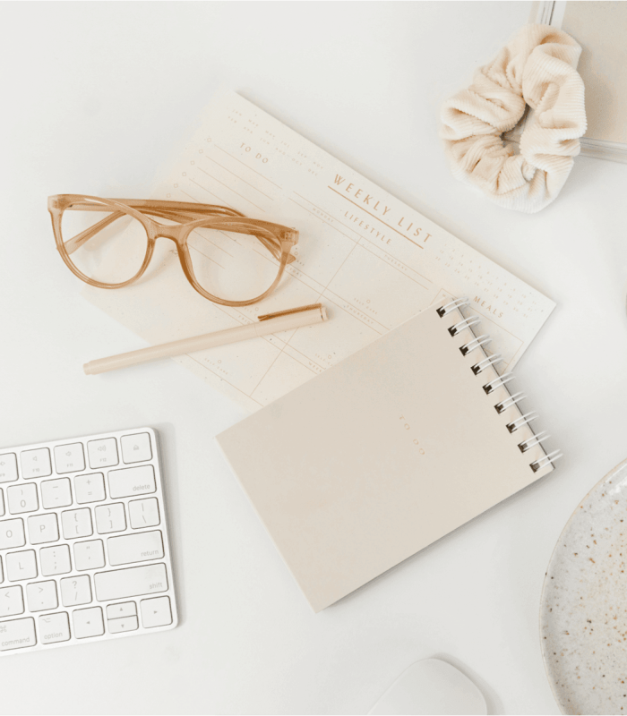 Styled desk with notebook and flowers